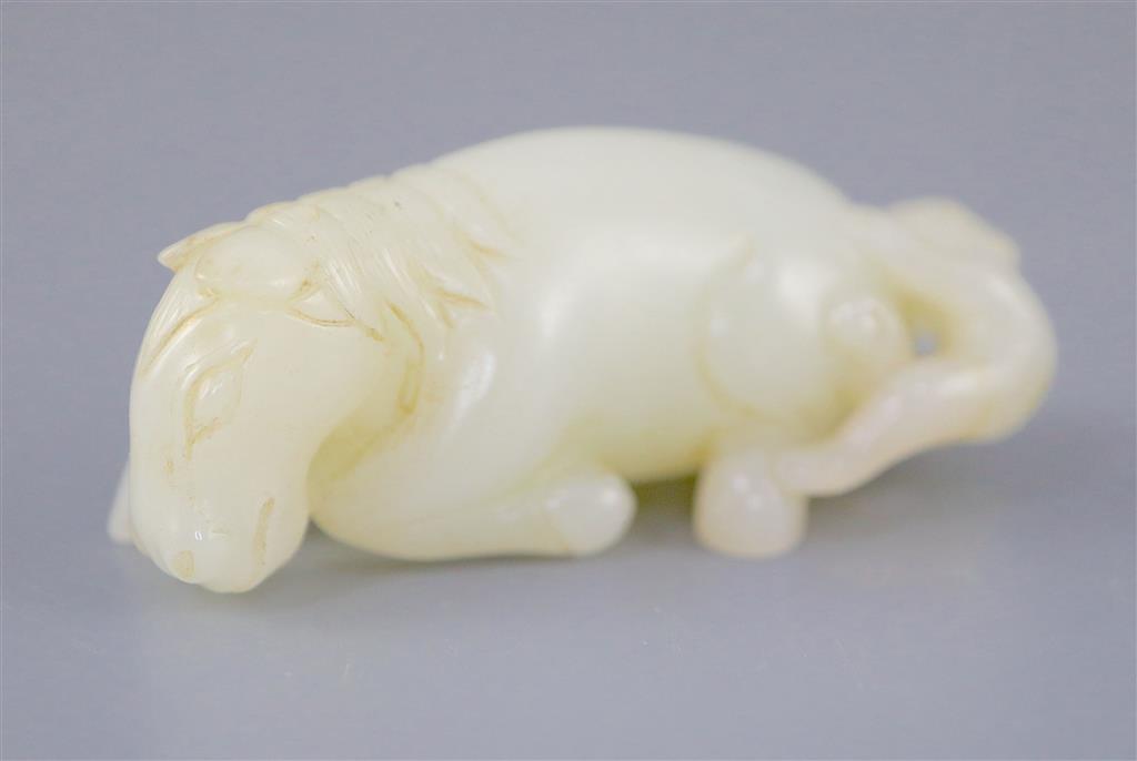 A Chinese white jade group of a recumbent horse and boy, 6cm long